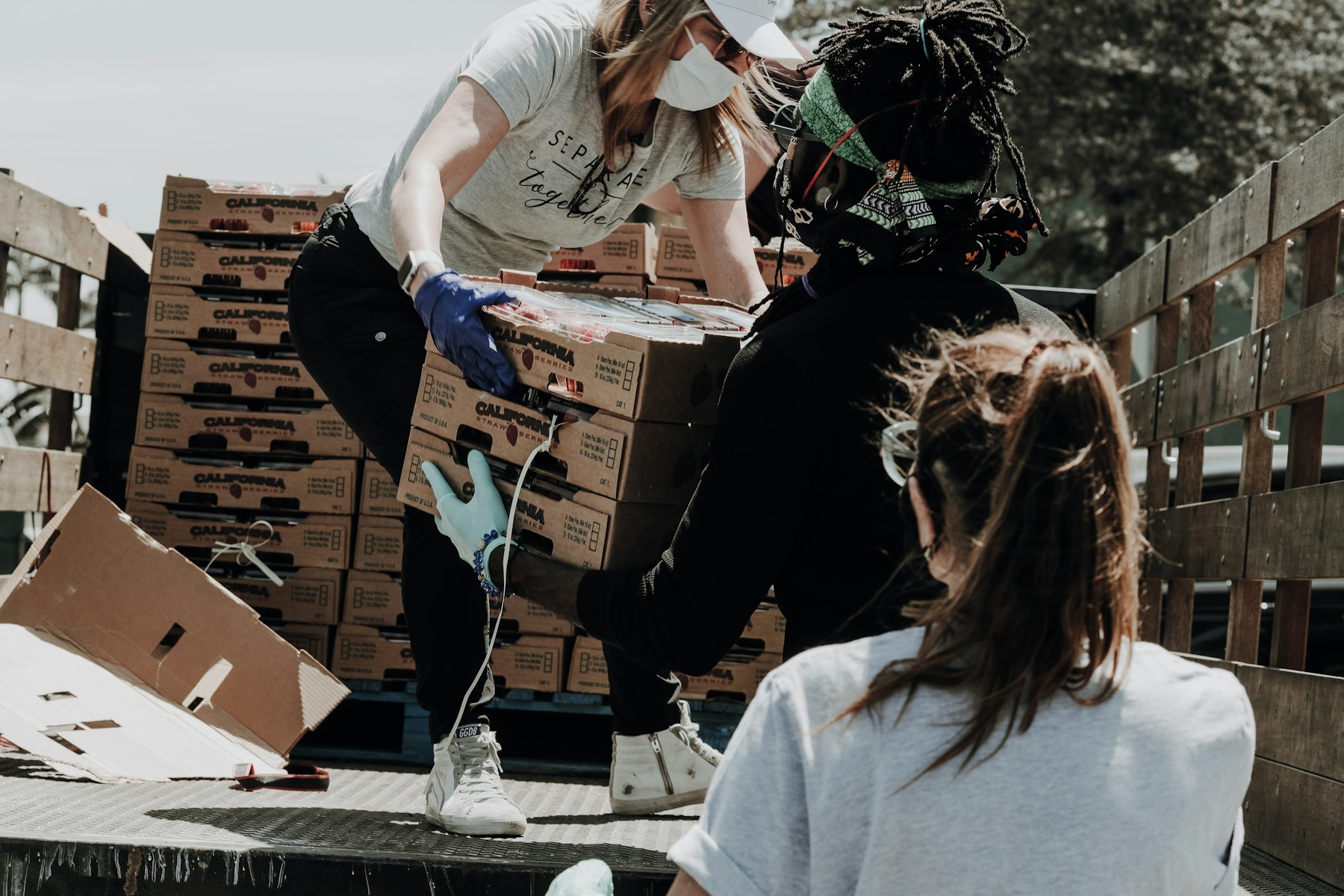 Community volunteers smiling while packing resource kits